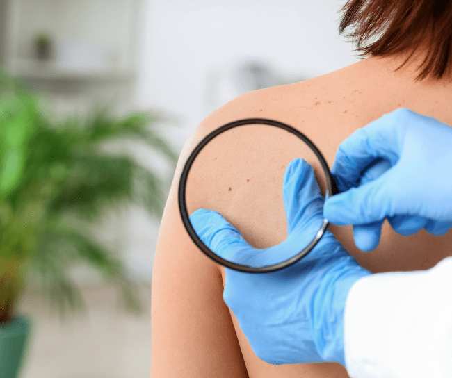 Dermatologist during patient examination